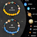 Two natural stone beaded bracelets for zodiac signs laid flat on a surface.