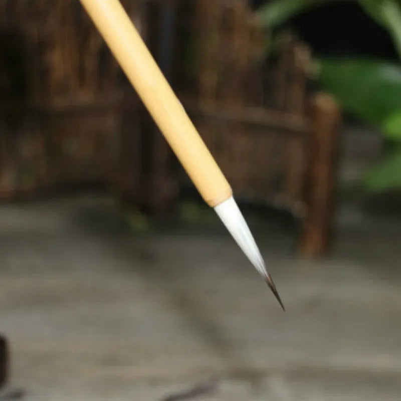 Four Chinese calligraphy brushes with mixed wolf wool and goat hair bristles on gold lacquer wooden bodies