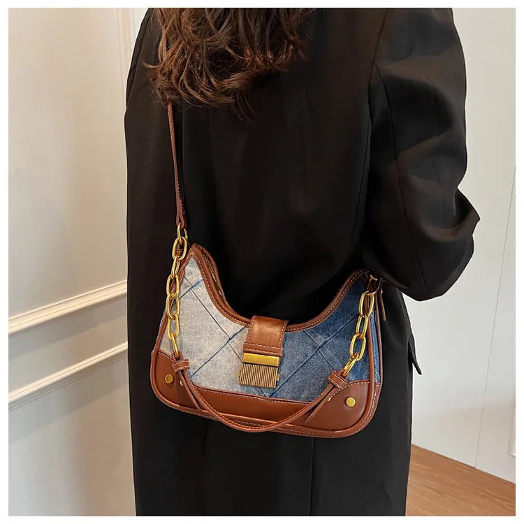 Brown denim women's bucket shoulder bag with diamond mesh detail and chain strap connector.