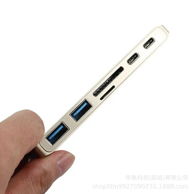 Compact USB-C hub with dual Type-C ports and SD card slot in grey aluminium finish