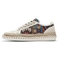 Men's beige and black cloth casual shoes with round toe, shown from the side.