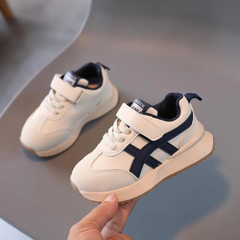 Children's white casual sneaker with Velcro strap, synthetic leather upper, and rubber sole
