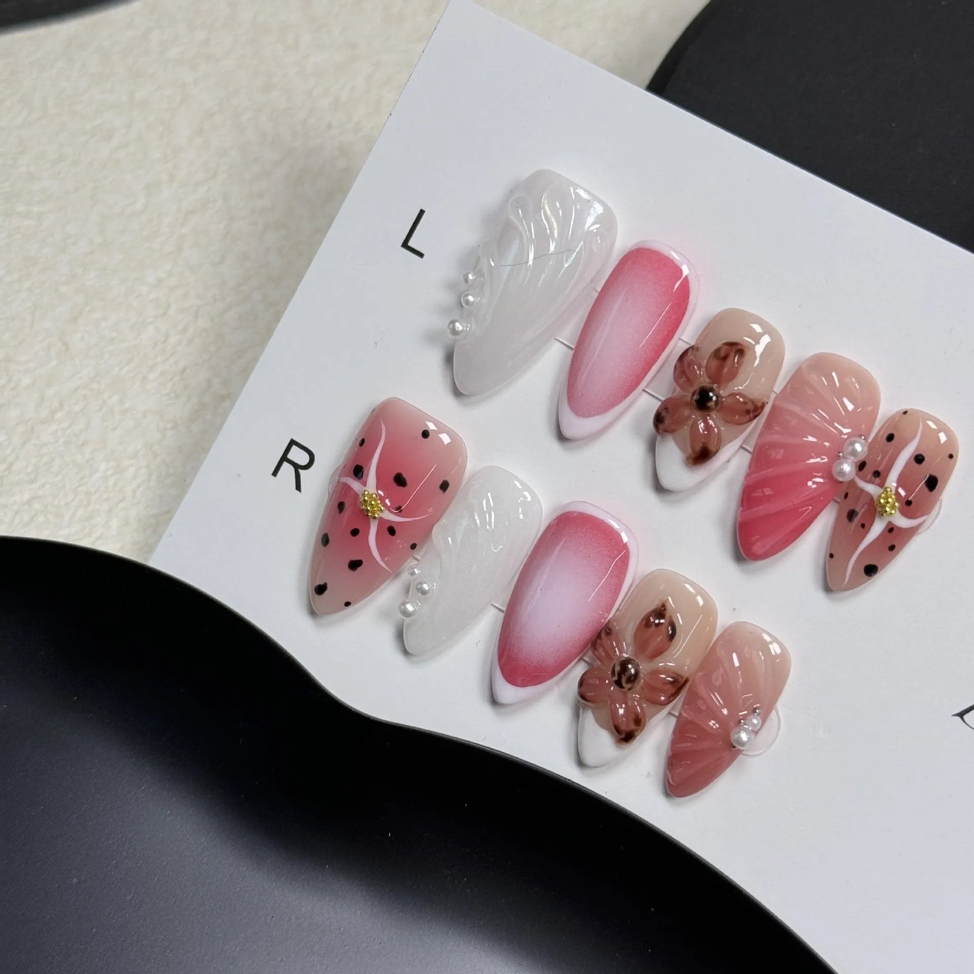 Close-up of hand-painted 3D carved nail art patches with colourful embossed candy patterns.