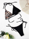 Women's red leopard print halter bikini with lace-up front on a mannequin