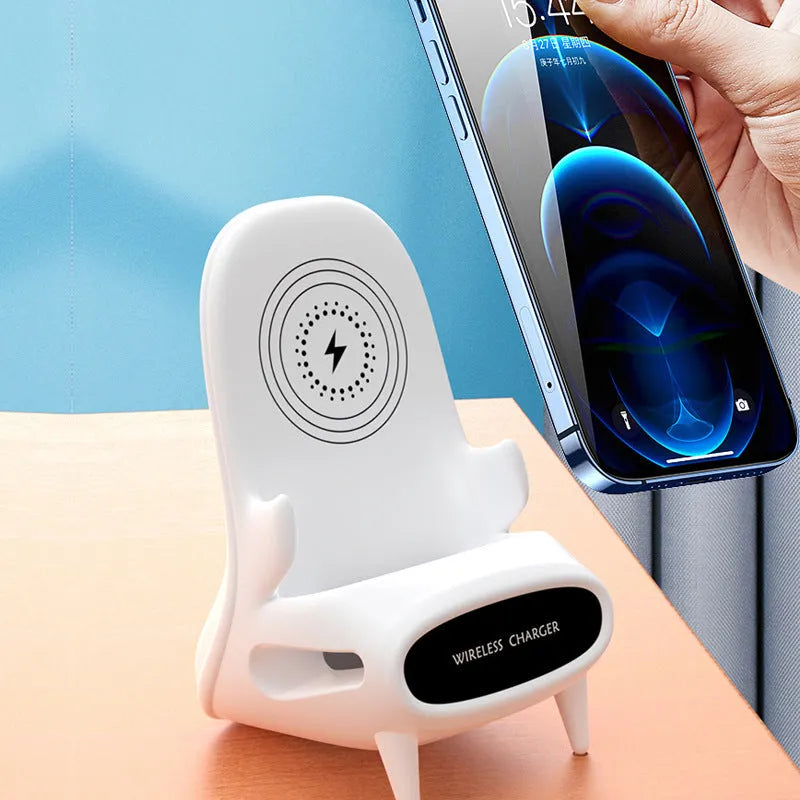 White mini chair shaped wireless charging stand holding smartphone with cable connection