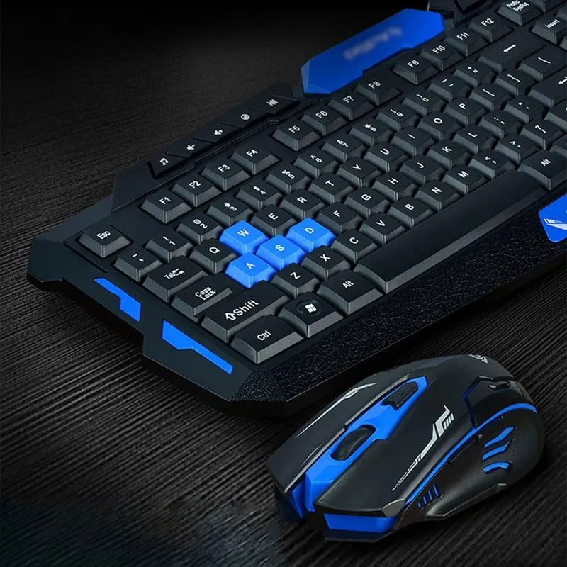 Black and blue wireless keyboard and mouse set on a desk, showing ergonomic design.