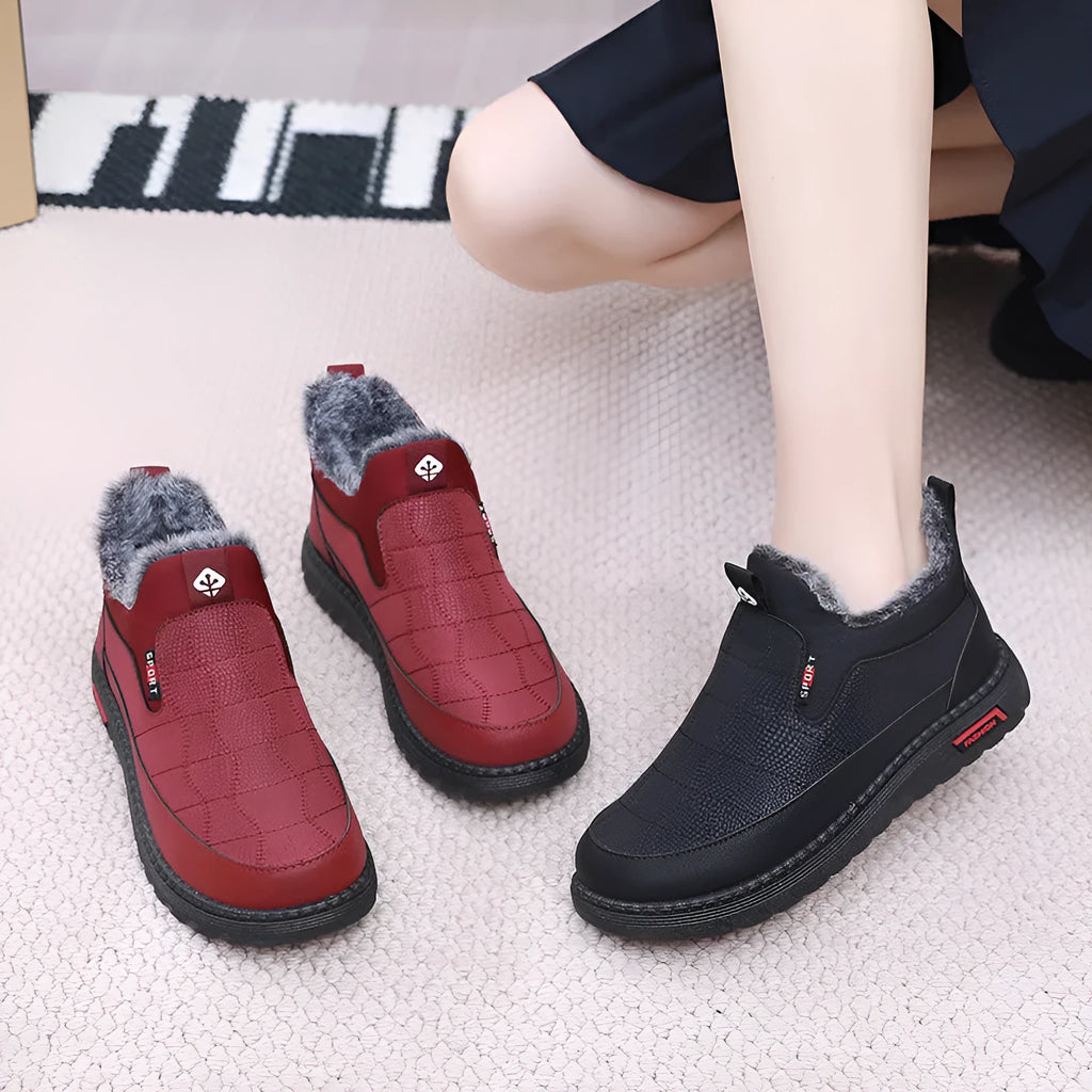 Women's black casual flat ankle boots with round toe and low shaft on a white background.