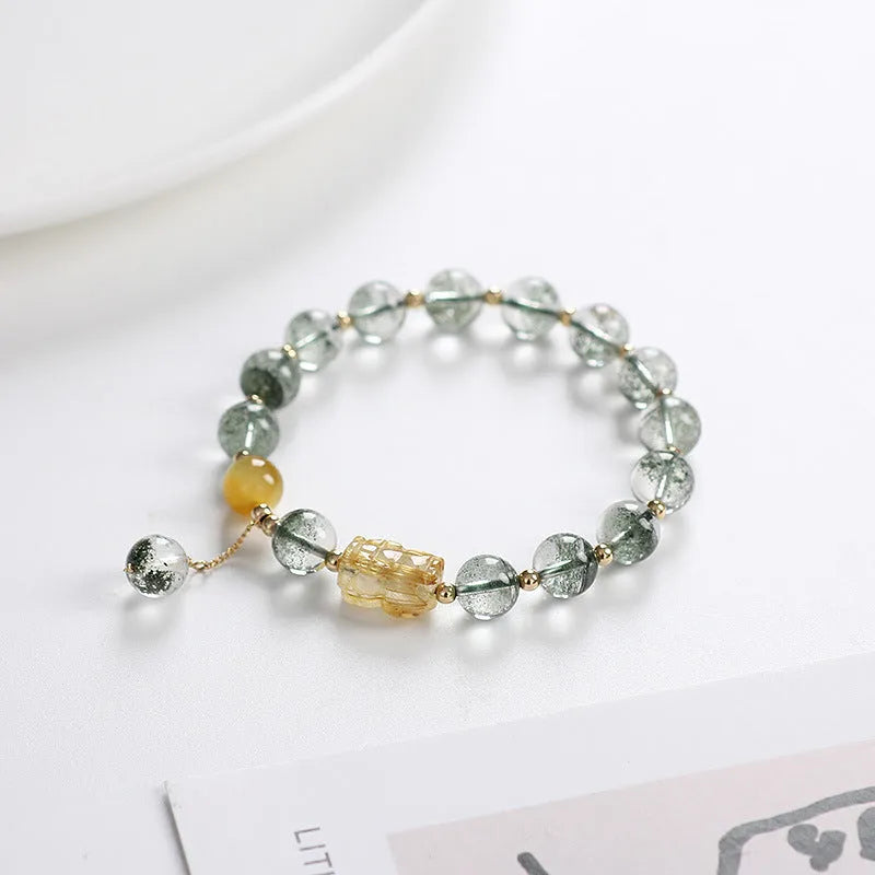 Green phantom quartz crystal bracelet with gold rutilated strands and 8mm geometric beads