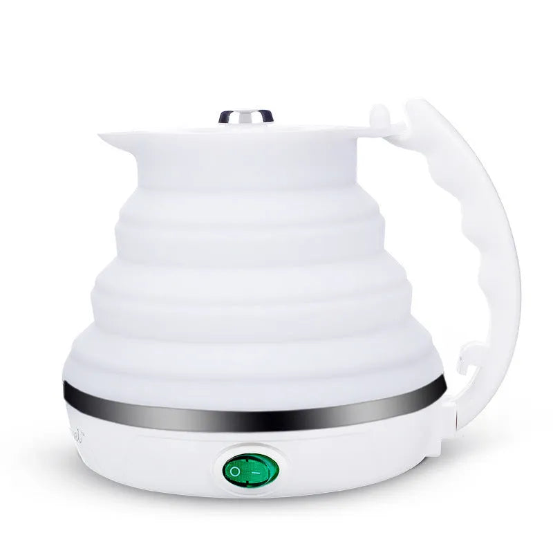 Foldable electric kettle 555ml in blue silicone collapsed on table with push button and short power cord