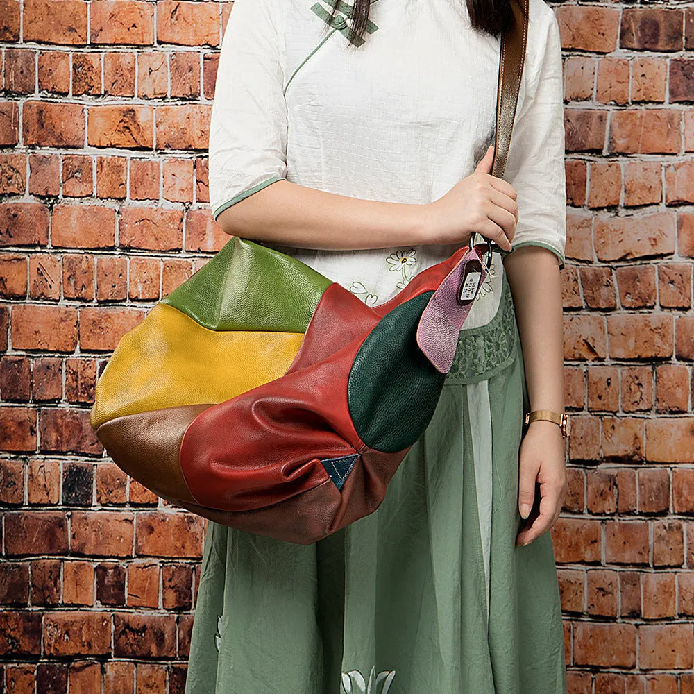 Brown cowhide leather crossbody travel bag open to show space for a 15-inch laptop and A4 documents.