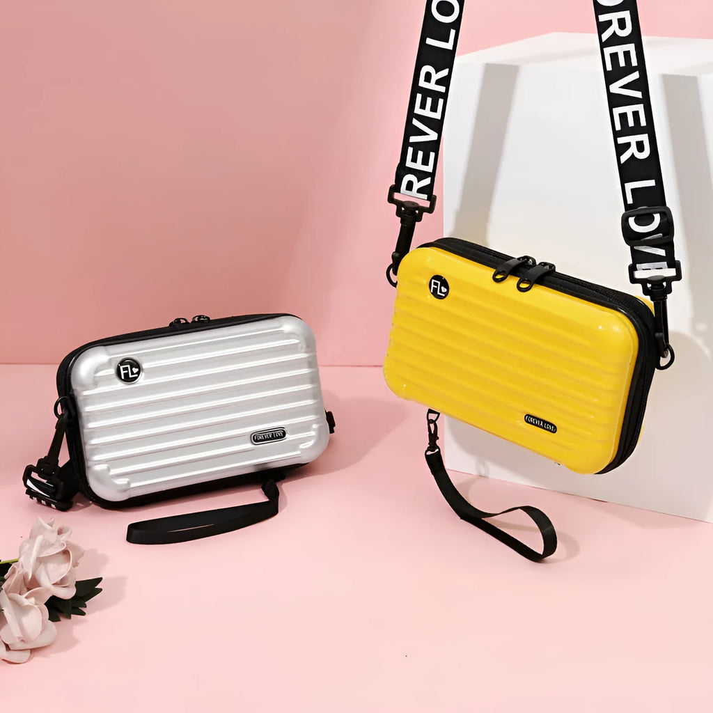 Mini suitcase mobile phone bag in horizontal square shape with single strap, zip closure, PVC outer and polyester lining.