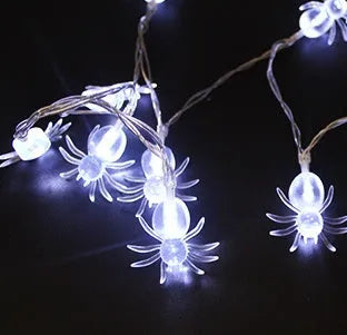 Halloween LED string lights with plastic pumpkin, ghost and bat decorations hanging on a 1.2 metre cable.