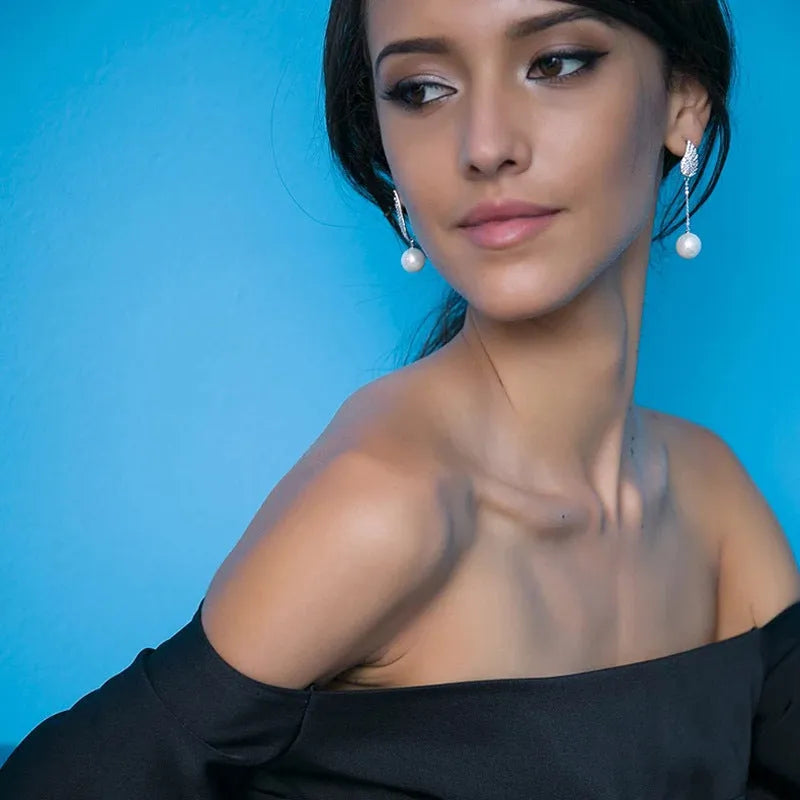Silver angel wing earrings with diamond-treated metal and gold-plated inlaid gemstones in platinum colour