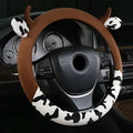 Black short plush automotive steering wheel cover showing protective handle feature