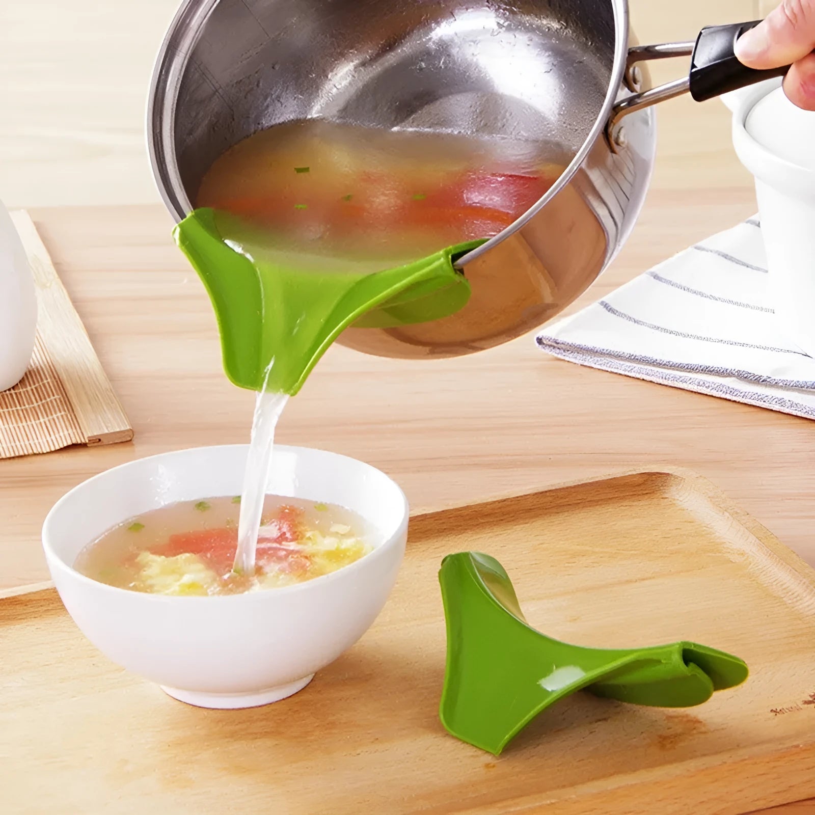 Green silicone kitchen funnel tool for circular pots with clamp design to prevent spills