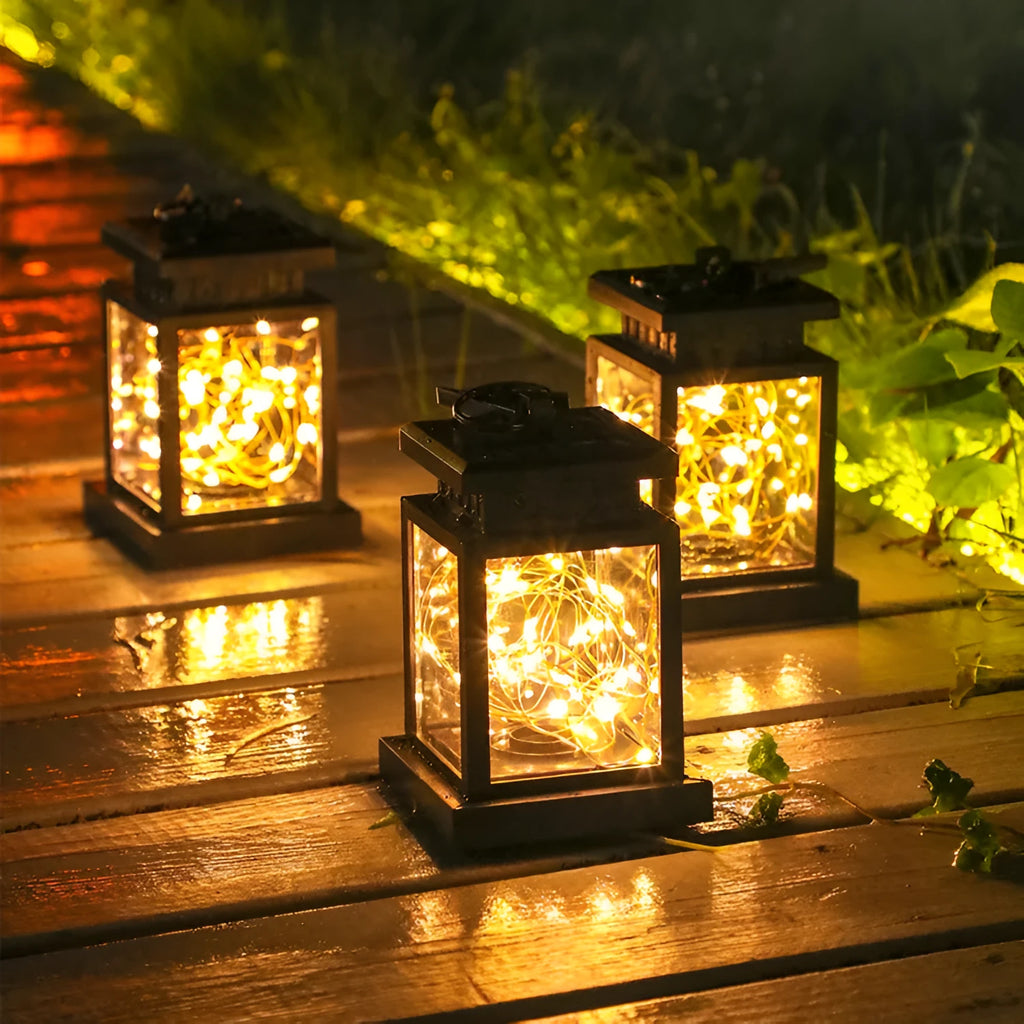 Black solar wind lamp with warm white LED light on outdoor table