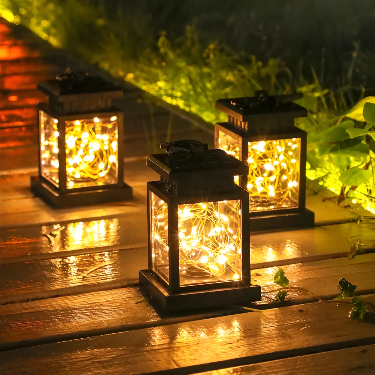 Black solar wind lamp with warm white LED light on outdoor table