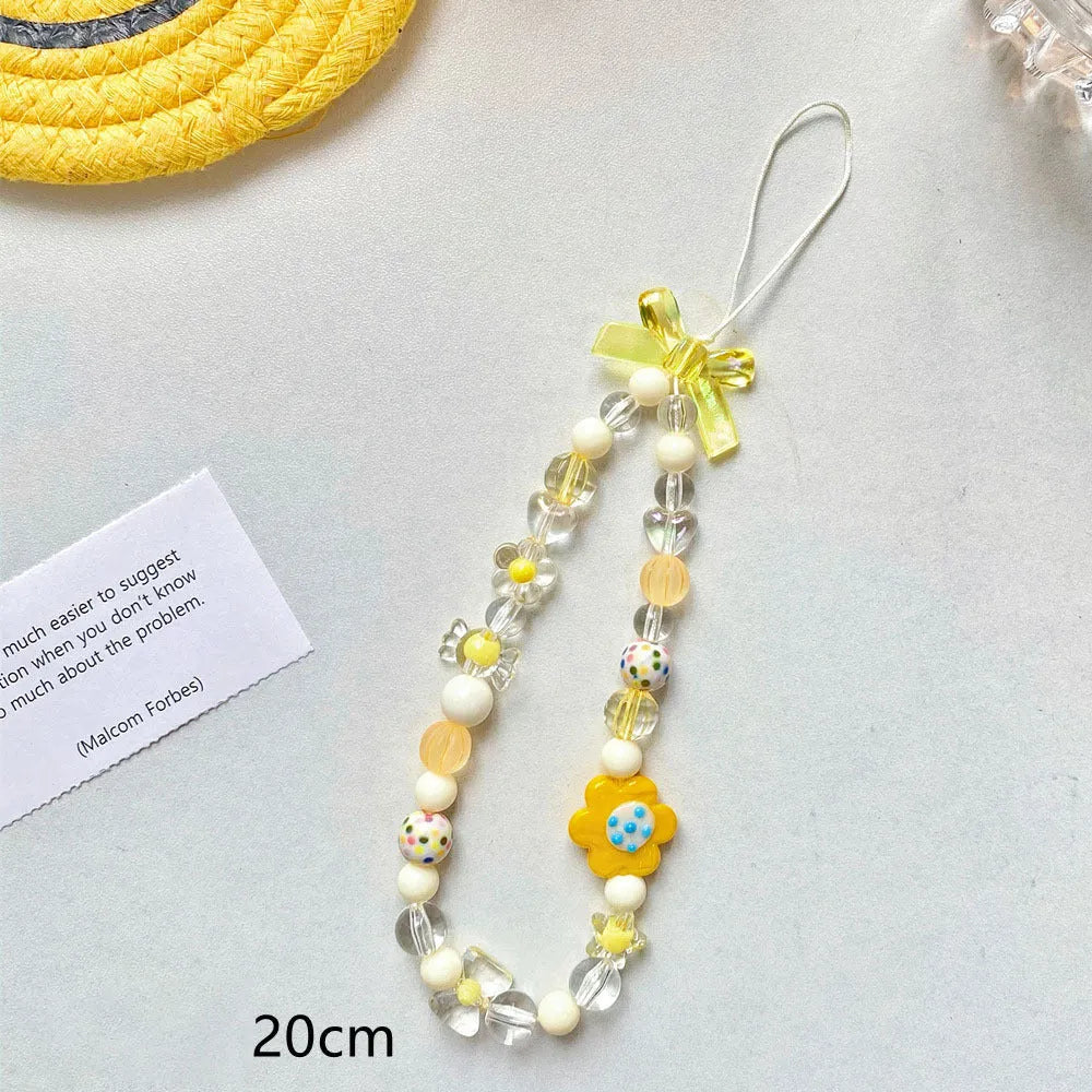 Close-up of a blue flower beaded phone lanyard with a rope strap for carrying mobile phones.