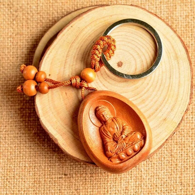 Eight patron saint keychains made of natural Taomu wood in orange colour, each measuring 10x3.2x4cm