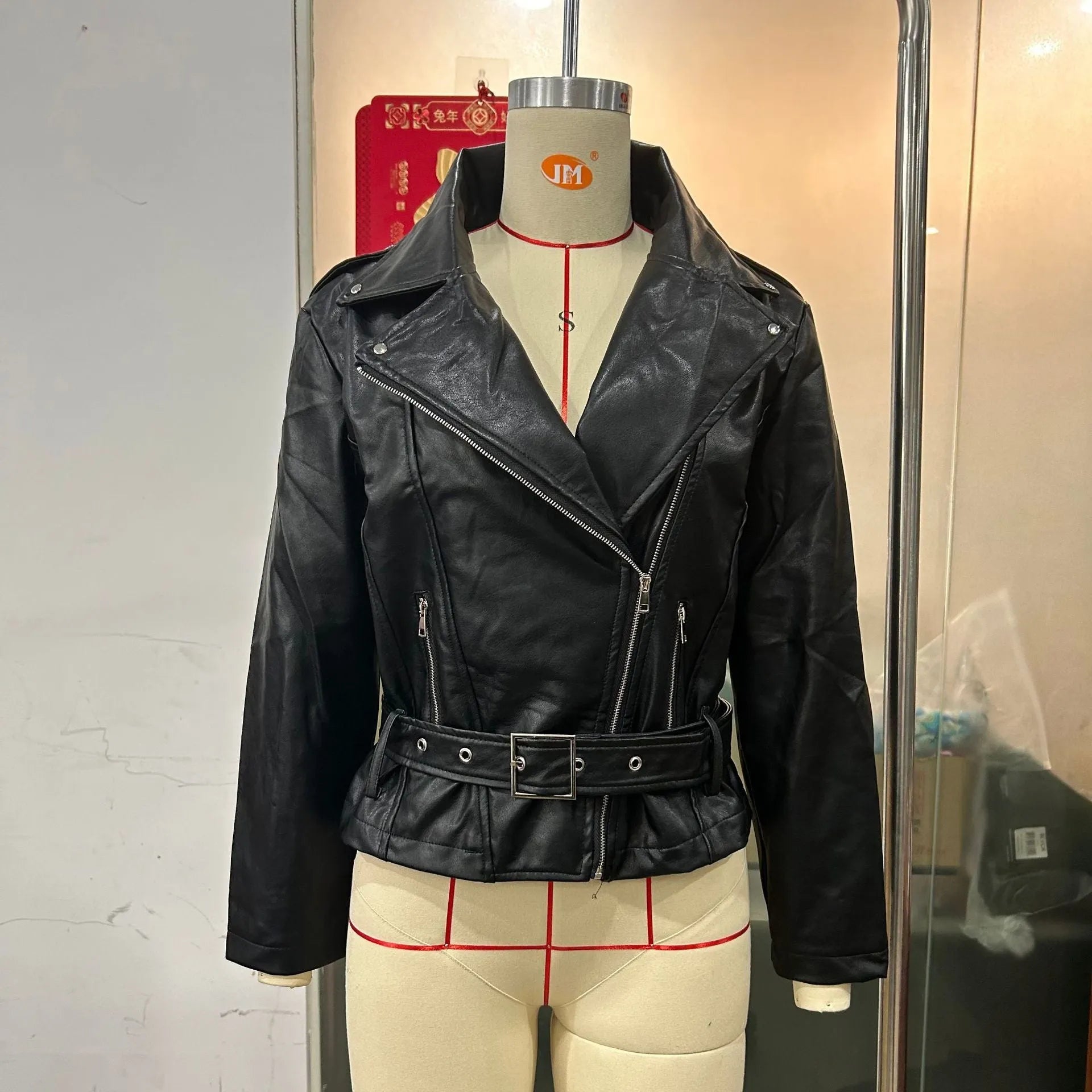Punk-style short belt lapel jacket in polyester fibre leather, available in black, blue, and green.