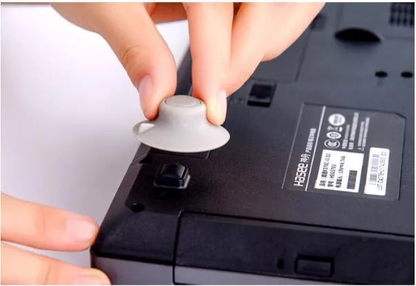 Grey durable plastic laptop cooling stand with two large and two small non-slip pads.