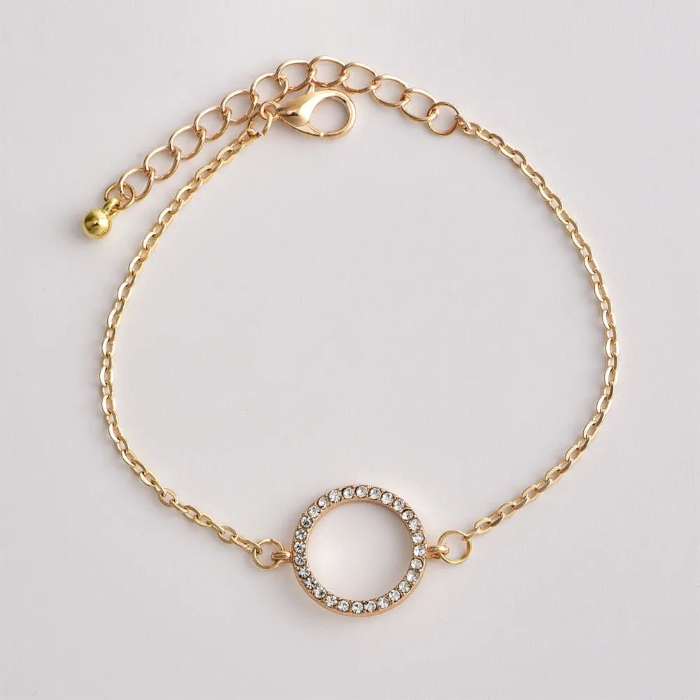 Gold alloy geometric bangle combination set with electroplated finish and about 16cm diameter