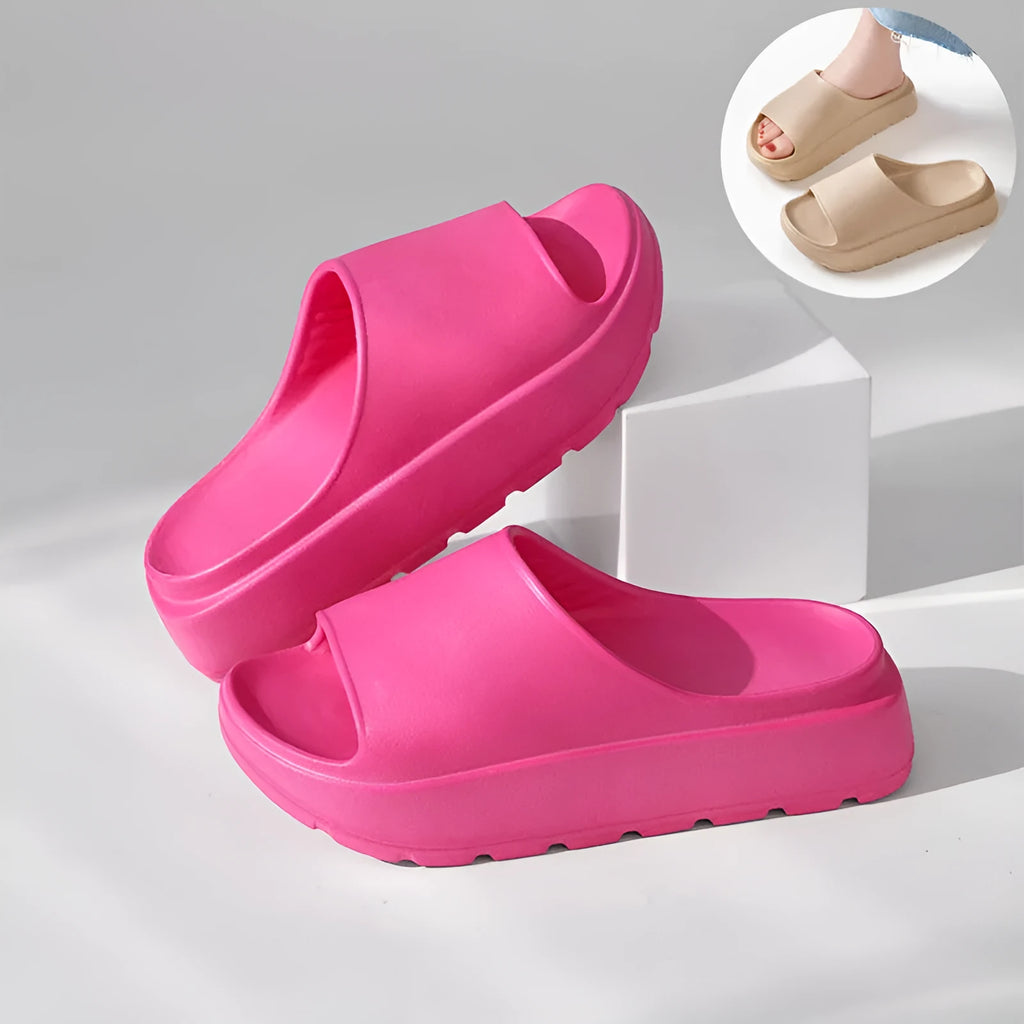 Women's beige fish mouth slippers with a thick 5.5cm EVA sole on a sandy beach.