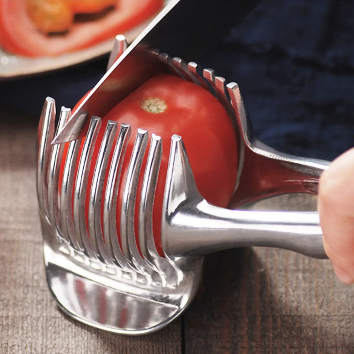 Silver plastic foldable lemon slicer kitchen gadget shown cutting citrus fruit