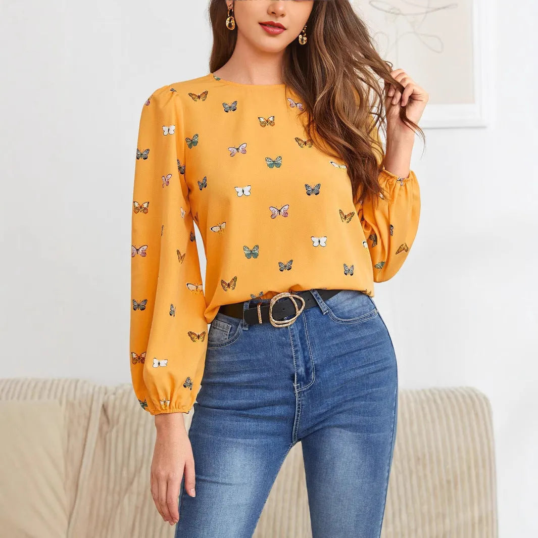 Women's green loose-fit long sleeve shirt with a colourful butterfly print.