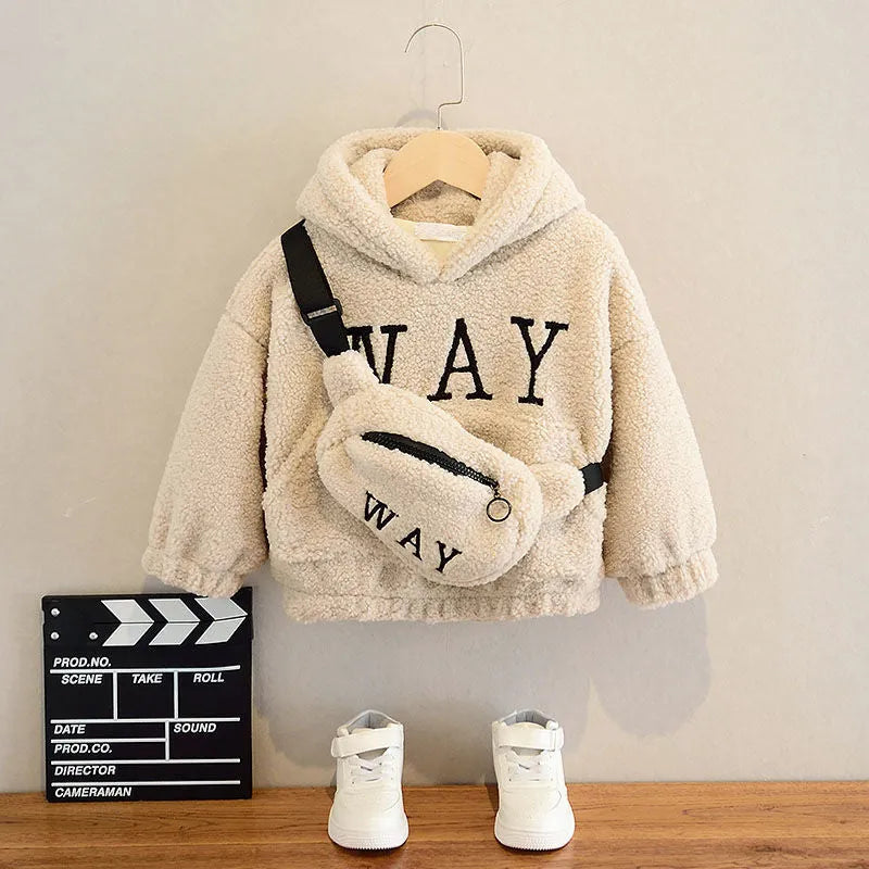 Child wearing a beige fleece hooded jacket with cartoon embroidery on the front.