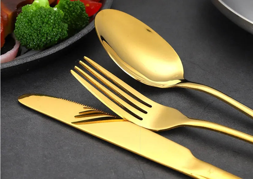 24 piece stainless steel cutlery set showing knives, forks and spoons in various colour finishes with one-piece moulding construction