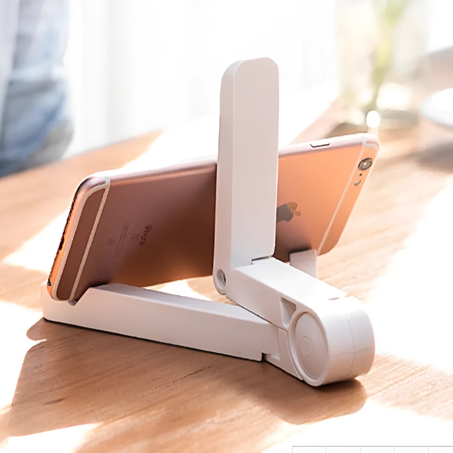 Black foldable tablet holder standing upright with a tablet in landscape mode on a desk