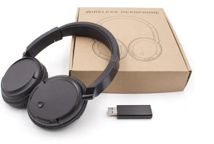 Black stereo wireless headset with USB FM transmitter and audio cable on a dark background
