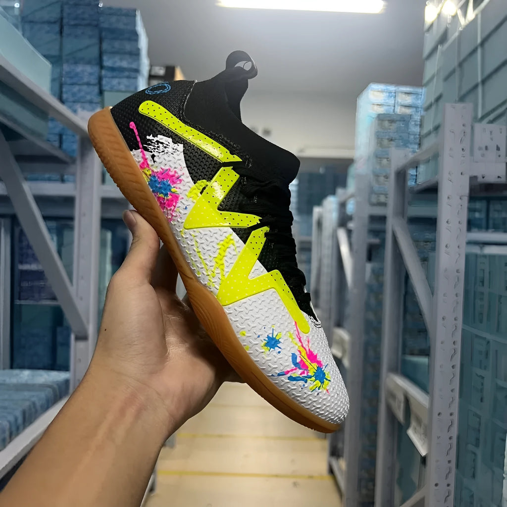 Black and yellow low-top football boots with removable studs on a non-slip rubber sole.