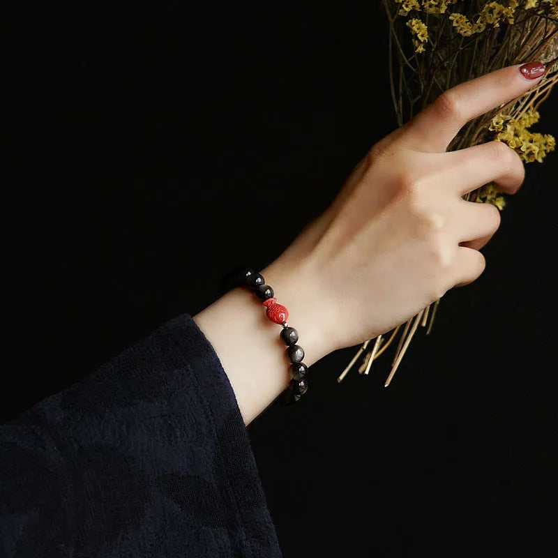 Natural obsidian round bead bracelet with red cinnabar accents and fungus decorative elements