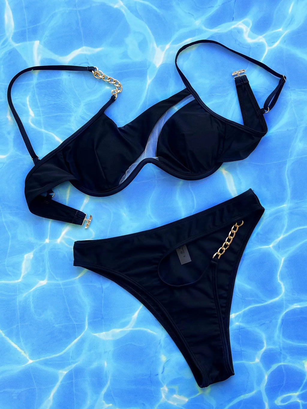 Black women's hollow split swimsuit bikini on a mannequin.