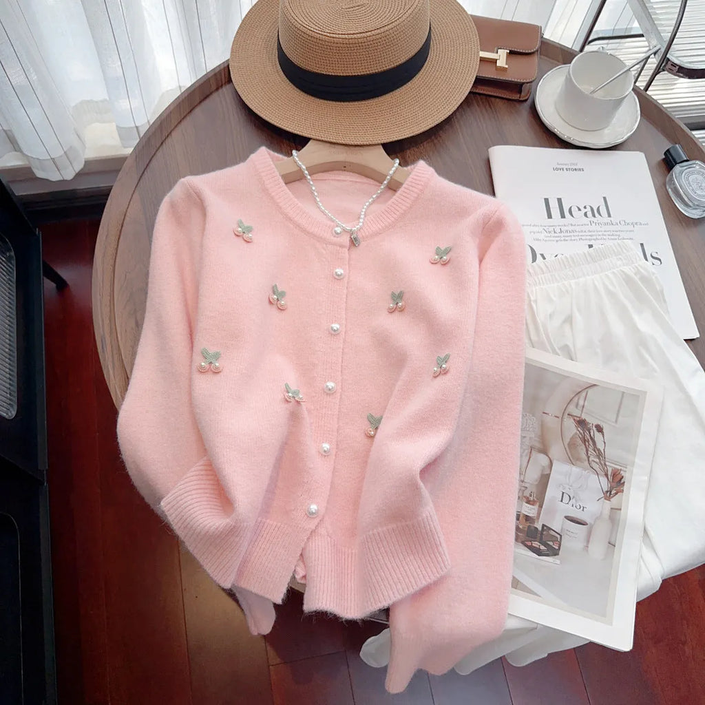 Women's pink cashmere cardigan sweater coat with bead detailing, round neck, and slim fit.