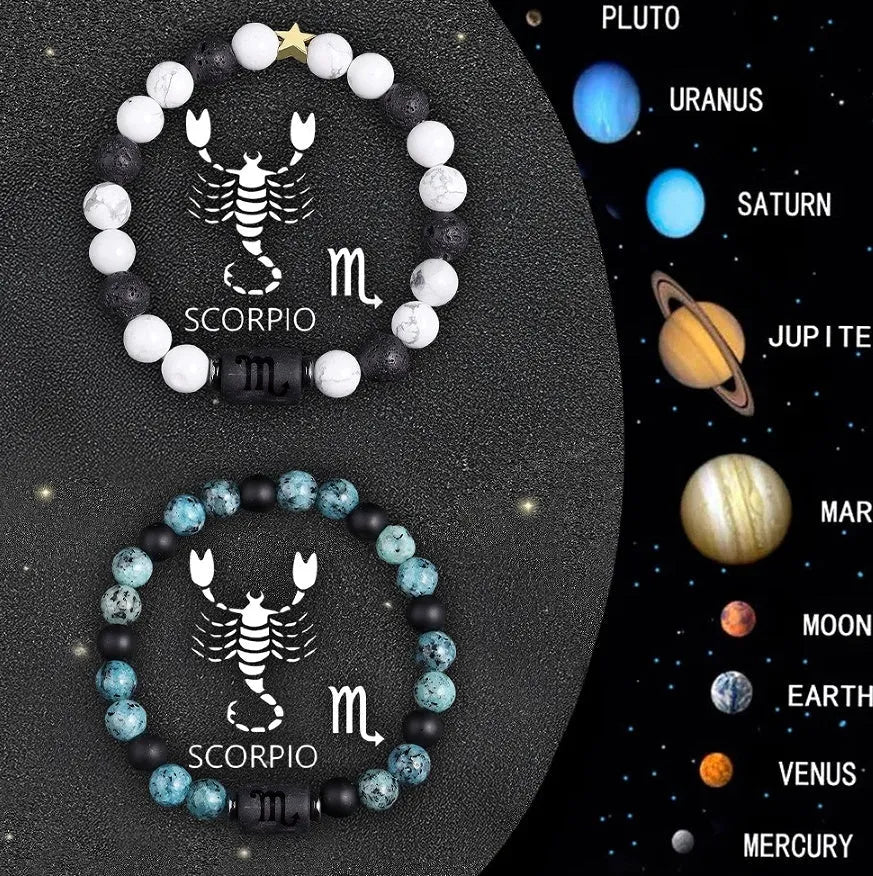 Two natural stone beaded bracelets for zodiac signs on a flat surface.