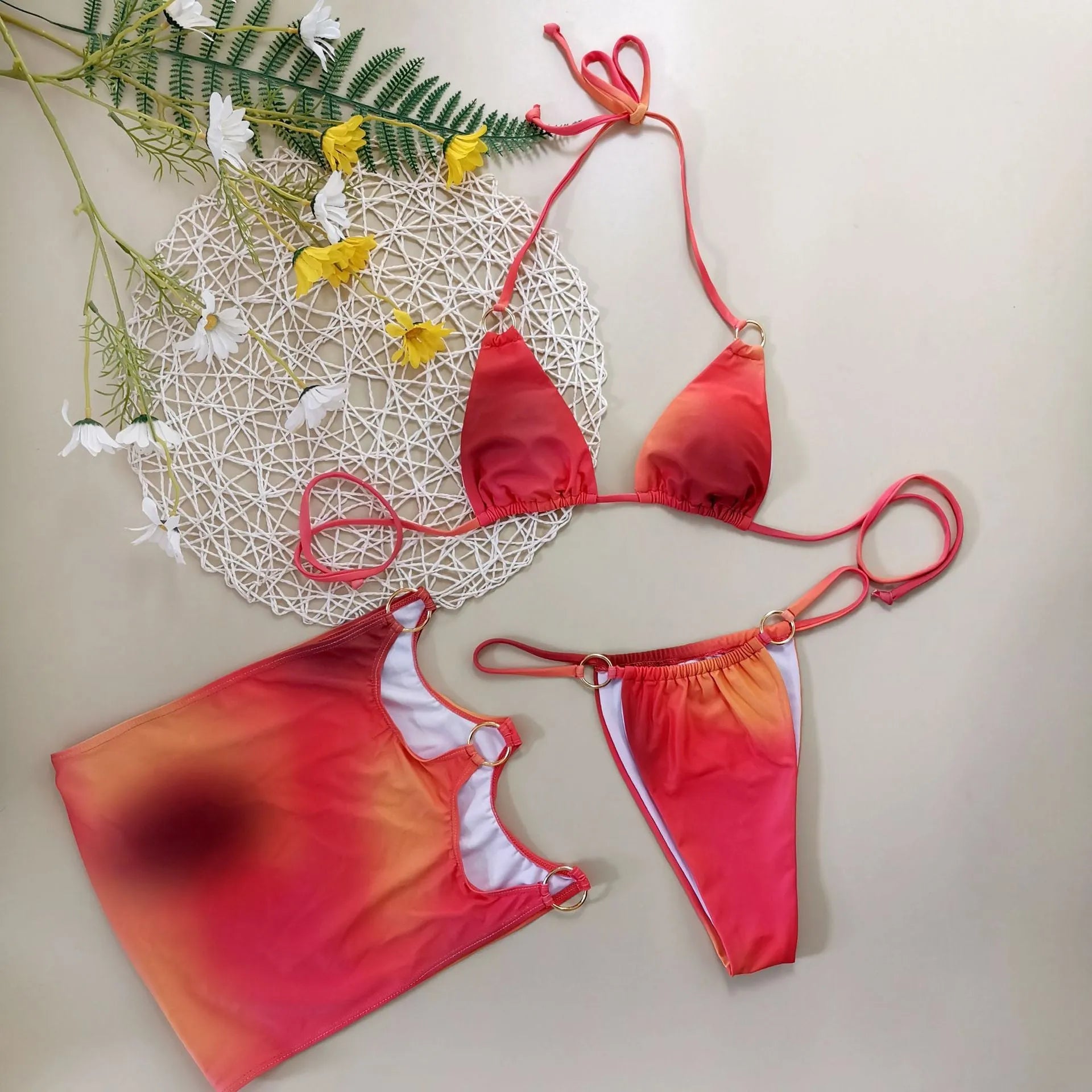 Solid-colour halterneck bikini three-piece swimsuit set with skirt, shown in sizes S, M, L.