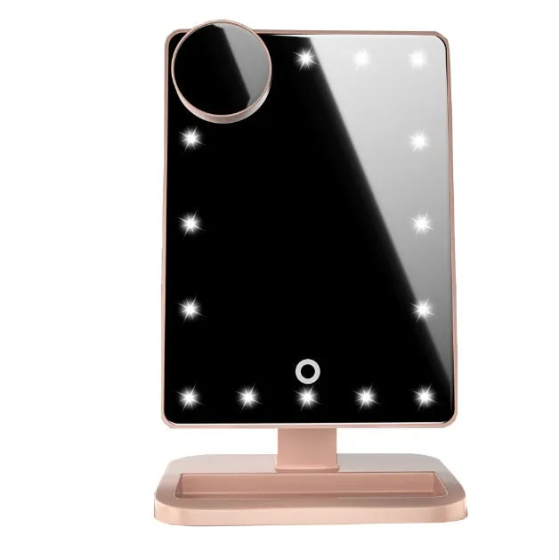 Pink touch screen makeup mirror with ring of 20 LED lights and built-in Bluetooth speaker on a dressing table.