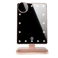 Pink touch screen makeup mirror with ring of 20 LED lights and built-in Bluetooth speaker on a dressing table.