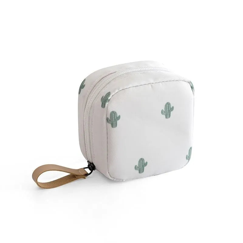 Blue cloth cube-shaped makeup storage bag on a plain background.