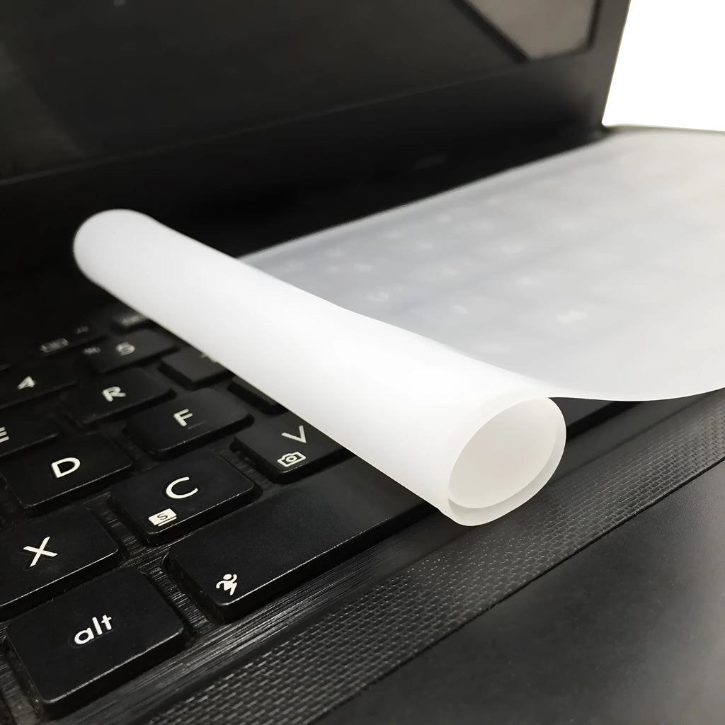 Transparent silicone keyboard dust film for laptop, showing close fit over keys