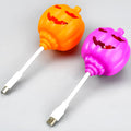 Plastic pumpkin lamp with USB power cable showing yellow or purple light options