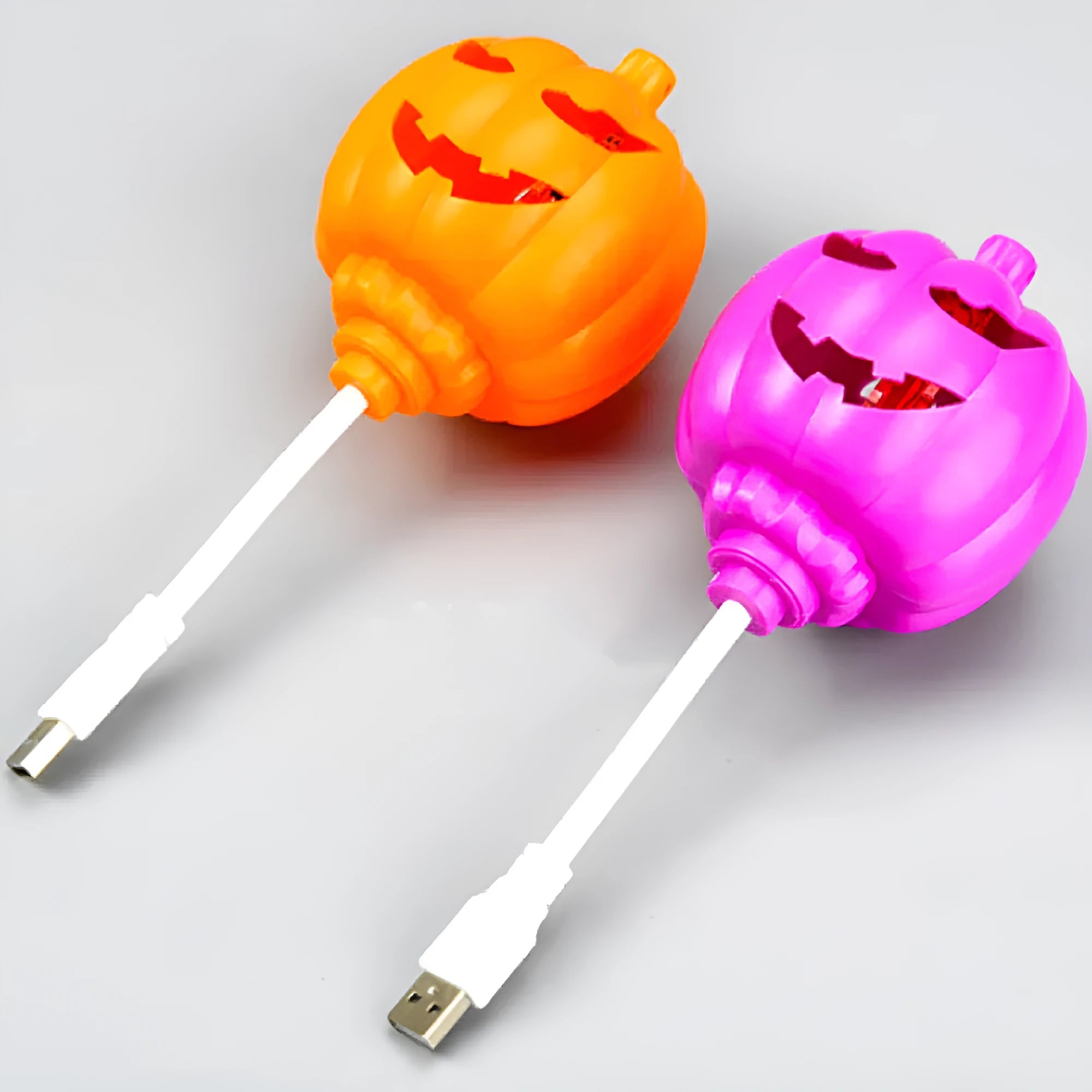 Plastic pumpkin lamp with USB power cable showing yellow or purple light options