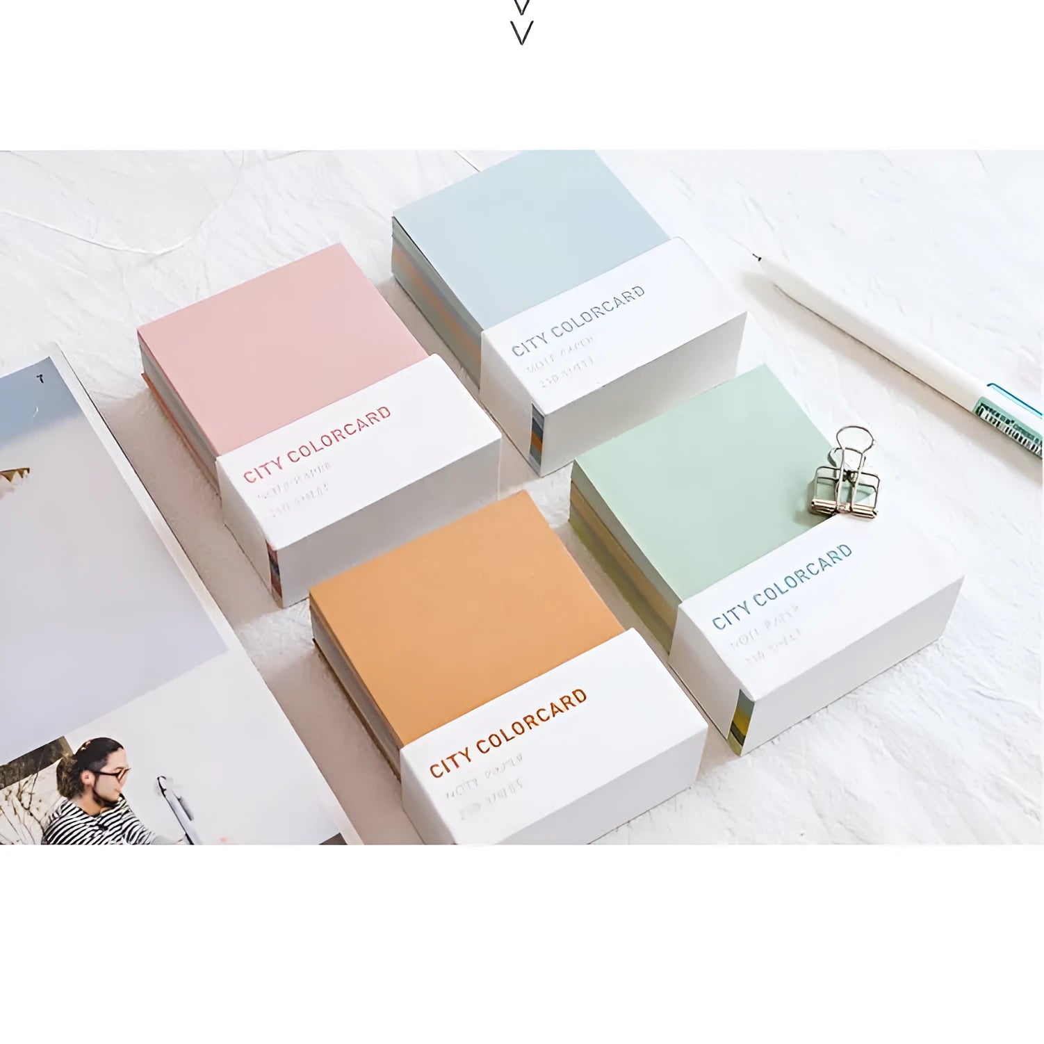 Set of rectangular paper memo notecards in four colour styles, shown with a pen, next to the OPP storage bag.