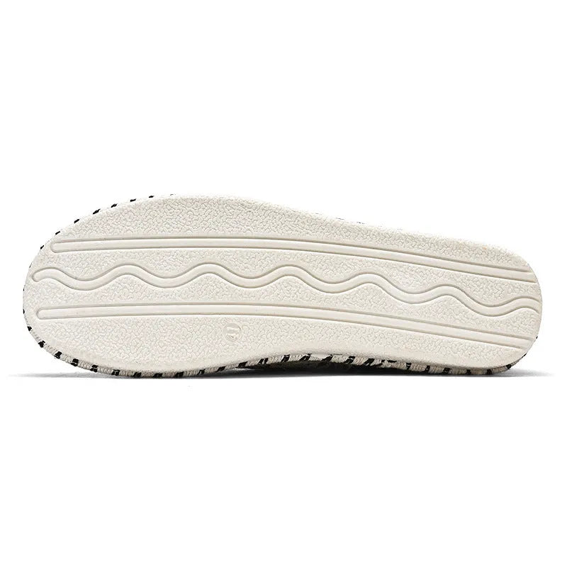 Men's beige and black cloth casual shoes with round toe, shown from the side.
