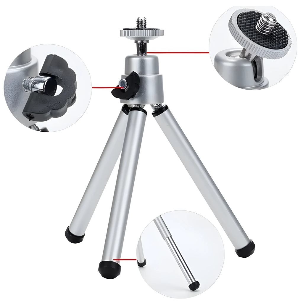 Black mini desktop camera tripod with extended legs and a U-shaped phone clip attached, on a white background.