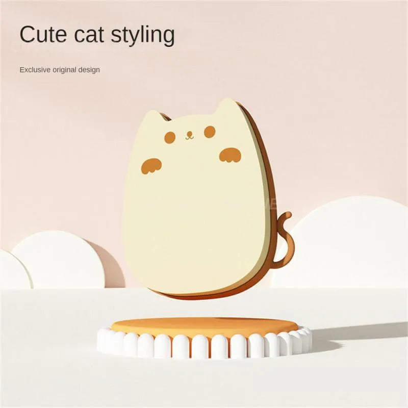 Brown sponge silicone pet hair removal brush with comb teeth on a wooden surface
