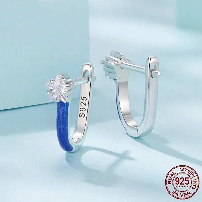 Pair of 925 sterling silver blue star pentagram ear clips with drip oil finish on white background